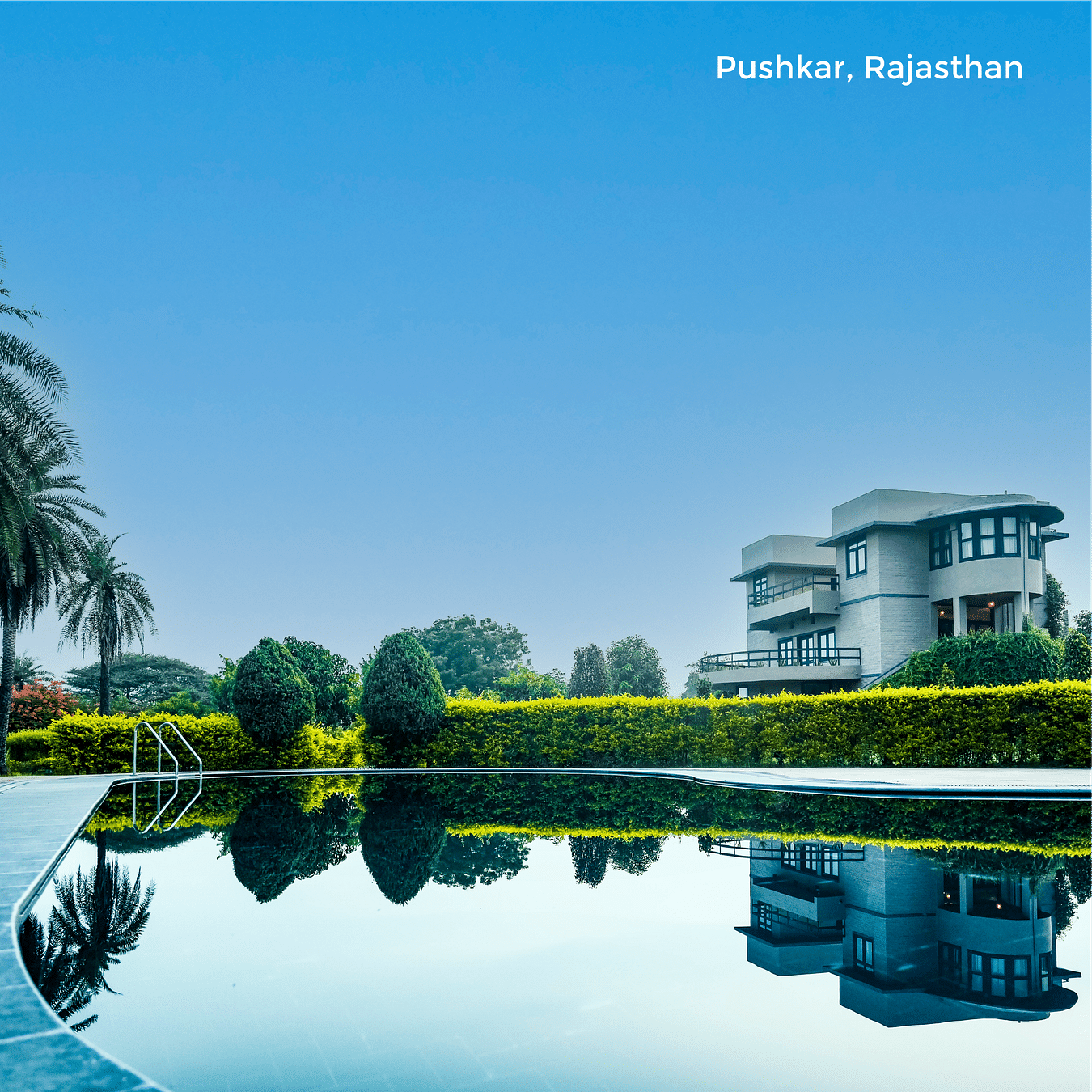 Image of the facade of Clarks Safari Pushkar reflecting on the waterbody as the text says Pushkar, Rajasthan
